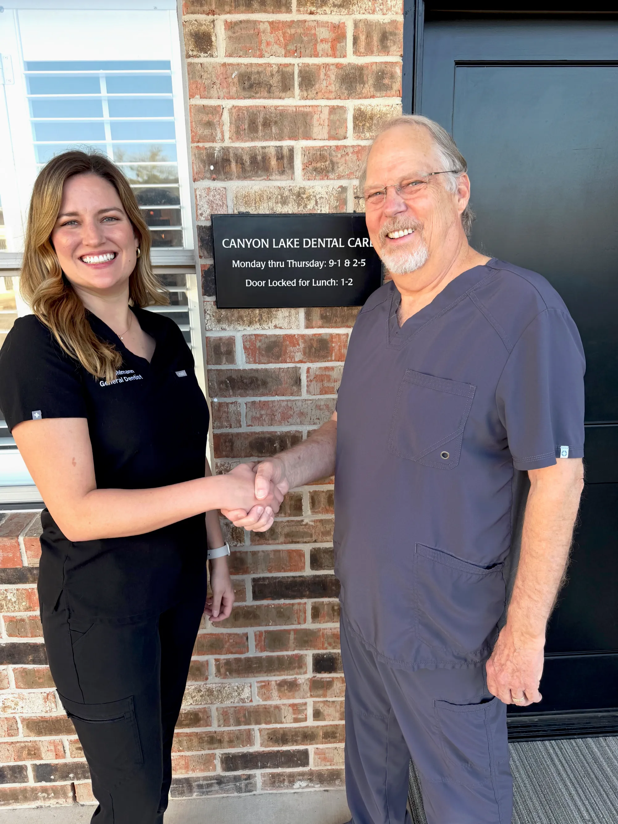 Dr. Elizabeth Pohlmann shaking hands with Dr. Fred H. Wilson III outside the practice